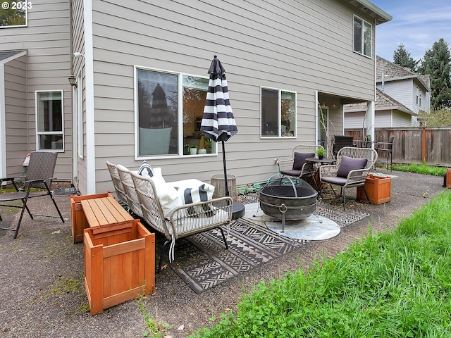 view of patio featuring an outdoor living space with a fire pit