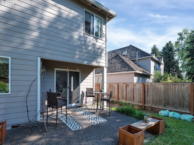 rear view of property featuring a patio