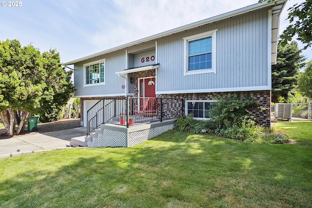 620 Sherman Dr, The Dalles, OR 97058 - split foyer home with driveway, an attached garage, a front yard, and brick siding