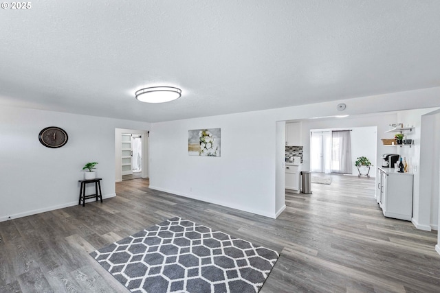586 11th Ave, Coos Bay, OR 97420 - unfurnished living room with wood finished floors, baseboards, and a textured ceiling