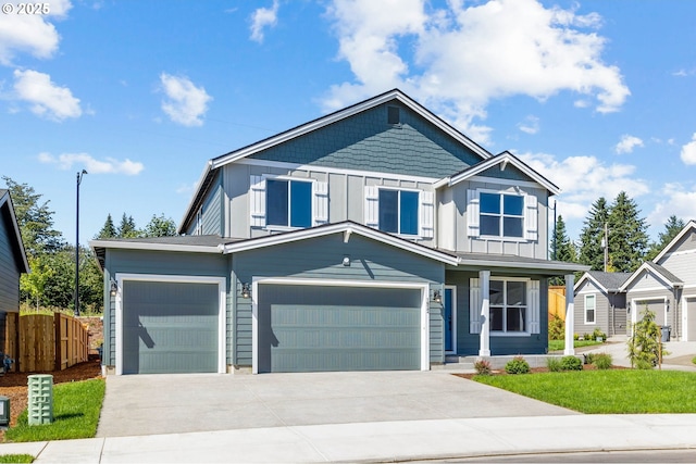 9389 N Hargrave St Unit Lt218, Camas, WA 98607 - view of front facade featuring fence, board and batten siding, concrete driveway, a porch, and an attached garage