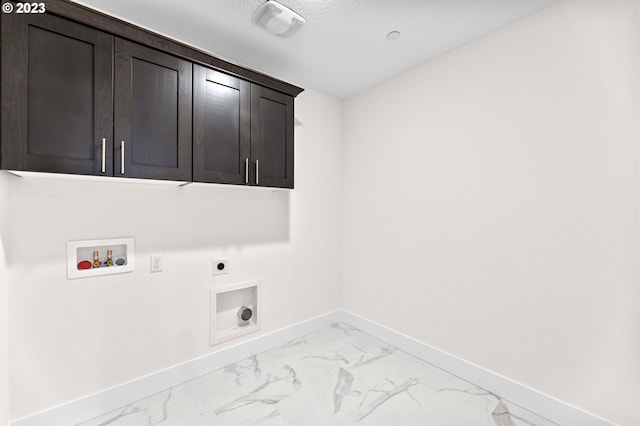 laundry area with hookup for an electric dryer, washer hookup, baseboards, marble finish floor, and cabinet space