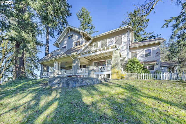 view of front of house with a porch and a front yard