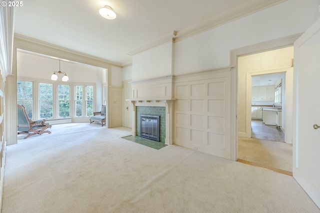 unfurnished living room featuring crown molding and light carpet