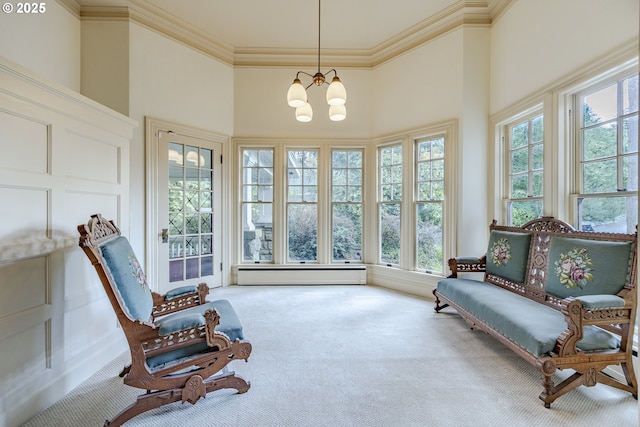 sunroom / solarium featuring an inviting chandelier and a baseboard radiator