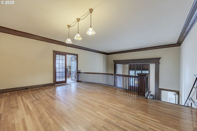 unfurnished room with ornamental molding and light hardwood / wood-style floors