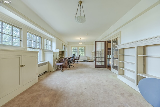 unfurnished office with french doors, light colored carpet, and radiator