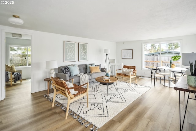 living room featuring baseboards and light wood-style flooring