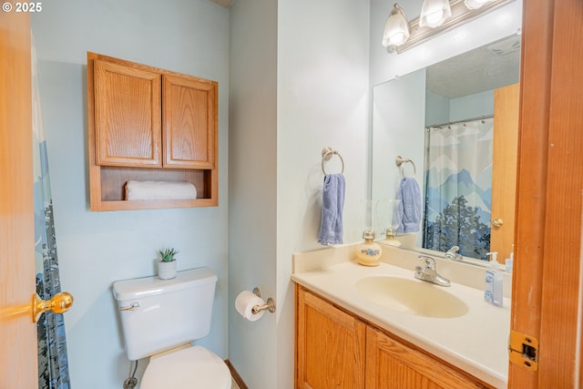 bathroom with visible vents, toilet, and vanity