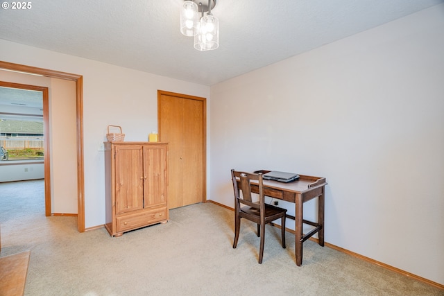 office featuring baseboards and light carpet