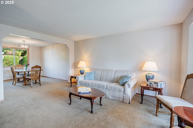 living room featuring light colored carpet, a chandelier, and a textured ceiling