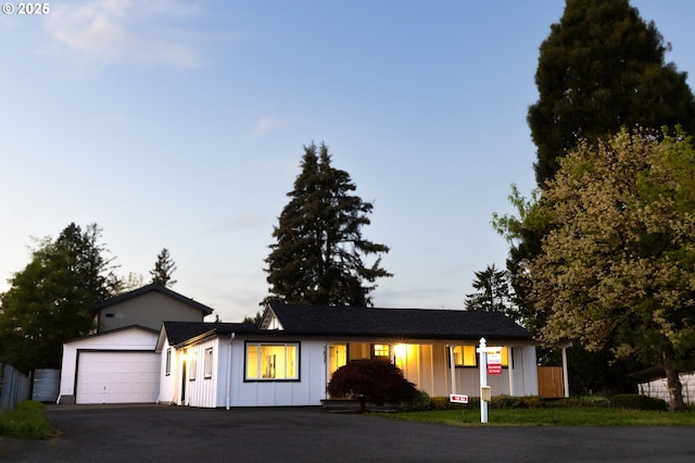 single story home featuring board and batten siding and driveway