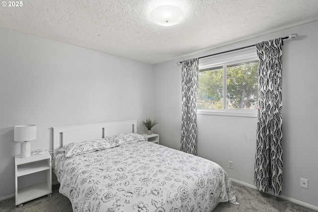 bedroom featuring carpet and a textured ceiling