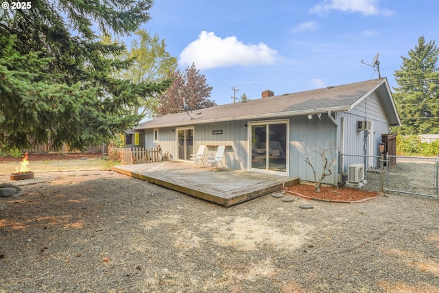 rear view of house with central AC unit and a deck