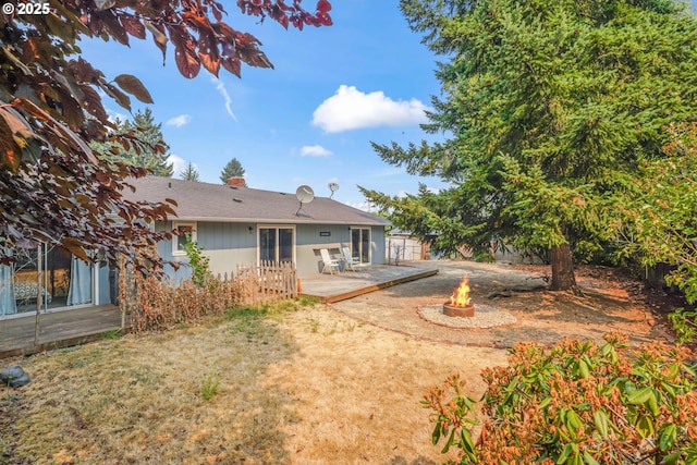 back of property featuring a fire pit