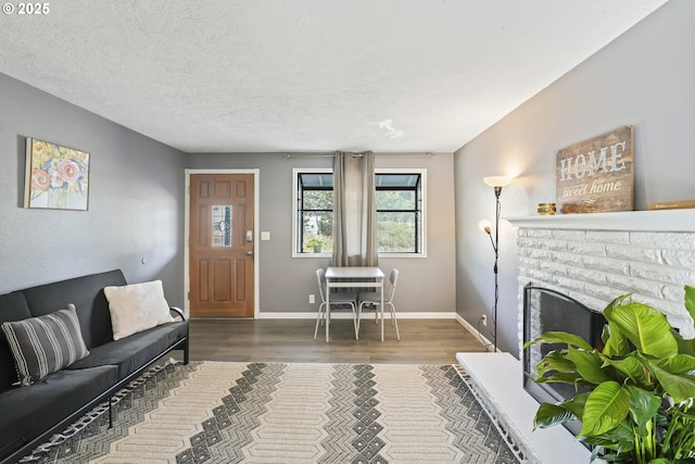 living room with dark hardwood / wood-style flooring and a textured ceiling