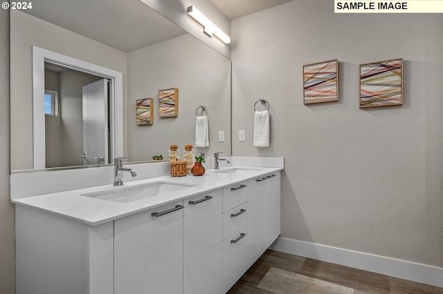 16755 SE Shimmering Leaf St, Happy Valley, OR 97086 - bathroom with baseboards, a sink, wood finished floors, and double vanity