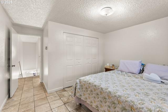 1720 17th St, Springfield, OR 97477 - bedroom with a closet, light tile patterned floors, and a textured ceiling