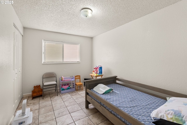 1720 17th St, Springfield, OR 97477 - bedroom with a closet, a textured ceiling, and light tile patterned floors