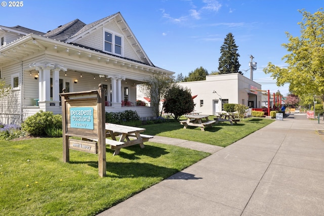 view of front facade with covered porch and a front lawn