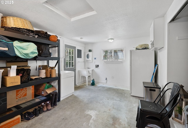 storage area with a sink, stacked washer / drying machine, and electric panel