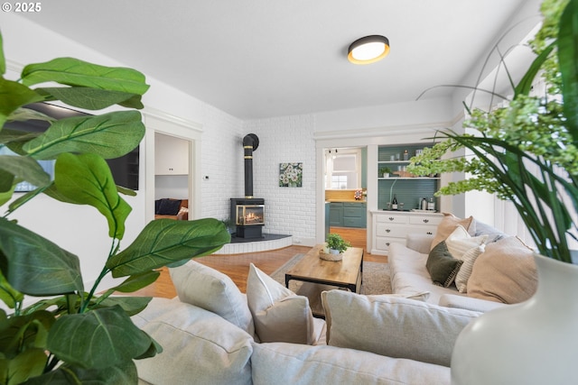 living room featuring wood finished floors and a wood stove