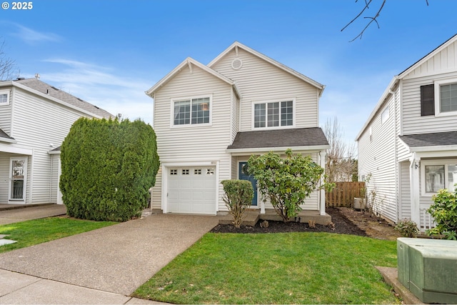 traditional-style home with fence, an attached garage, a shingled roof, concrete driveway, and a front lawn