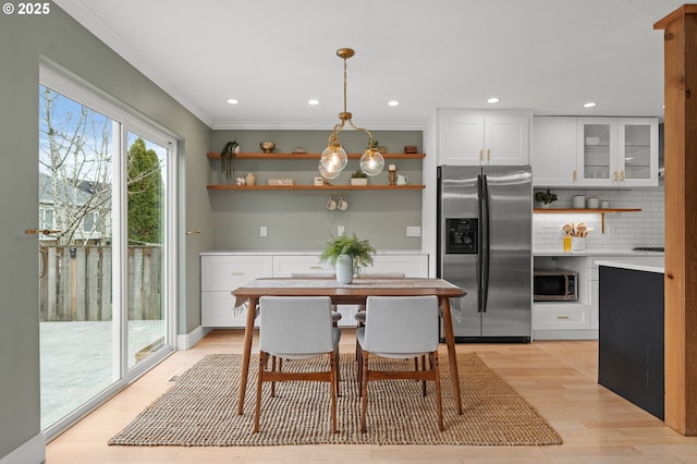 dining area featuring crown molding, recessed lighting, and light wood-type flooring