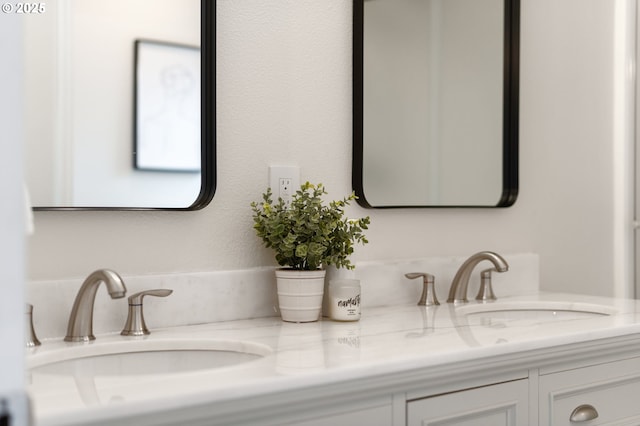 full bathroom with a sink and double vanity