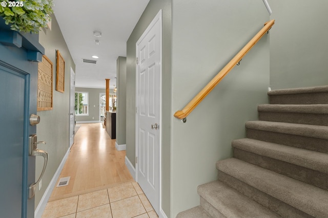 staircase with recessed lighting, visible vents, baseboards, and tile patterned flooring