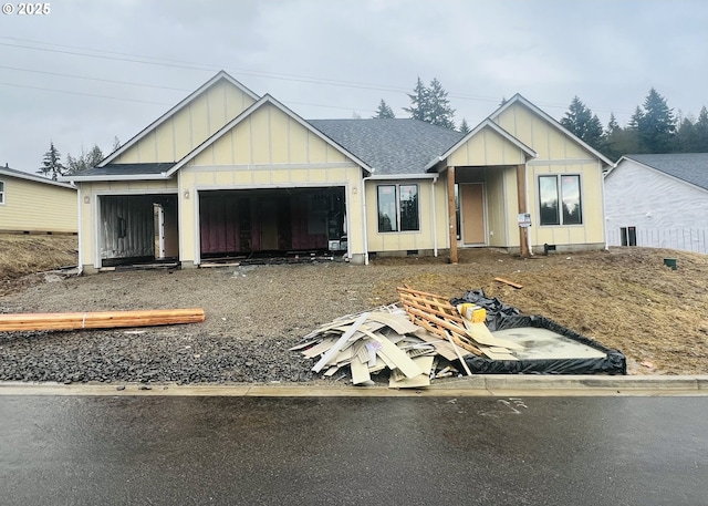 view of front facade featuring crawl space, a shingled roof, board and batten siding, and an attached garage