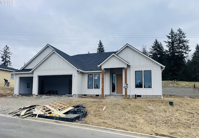 modern farmhouse featuring a garage, board and batten siding, roof with shingles, and crawl space