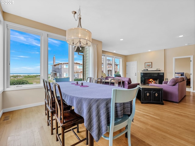 2385 Ocean Vista Dr, Seaside, OR 97138 - dining area featuring baseboards, light wood-style flooring, recessed lighting, and a tiled fireplace