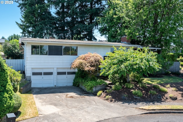 13530 NE Milton St, Portland, OR 97230 - view of front of house with concrete driveway, an attached garage, a chimney, and a shingled roof