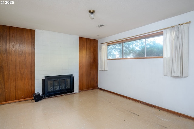 13530 NE Milton St, Portland, OR 97230 - unfurnished living room featuring tile patterned floors and a fireplace