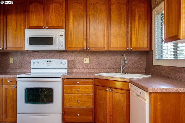 13530 NE Milton St, Portland, OR 97230 - kitchen featuring white appliances, brown cabinets, and backsplash