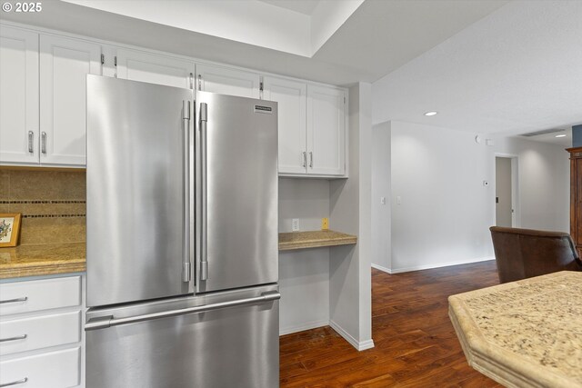 kitchen with white cabinetry, high quality fridge, dark hardwood / wood-style flooring, and decorative backsplash