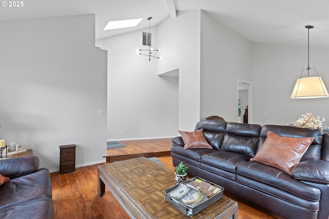 living room with hardwood / wood-style floors, a skylight, high vaulted ceiling, and beamed ceiling