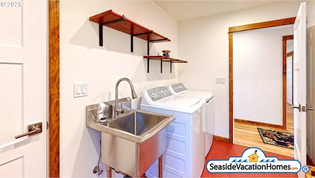 1560 S Edgewood St, Seaside, OR 97138 - washroom with washing machine and clothes dryer and wood finished floors