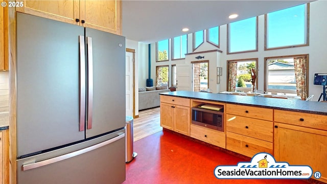 1560 S Edgewood St, Seaside, OR 97138 - kitchen with freestanding refrigerator, built in microwave, recessed lighting, open floor plan, and dark countertops