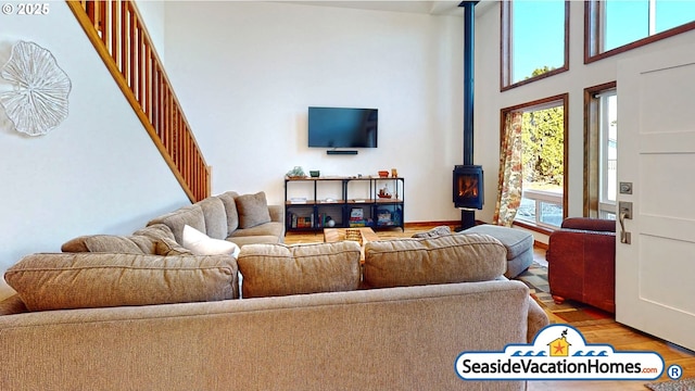 1560 S Edgewood St, Seaside, OR 97138 - living room with a wood stove, wood finished floors, a towering ceiling, and stairway