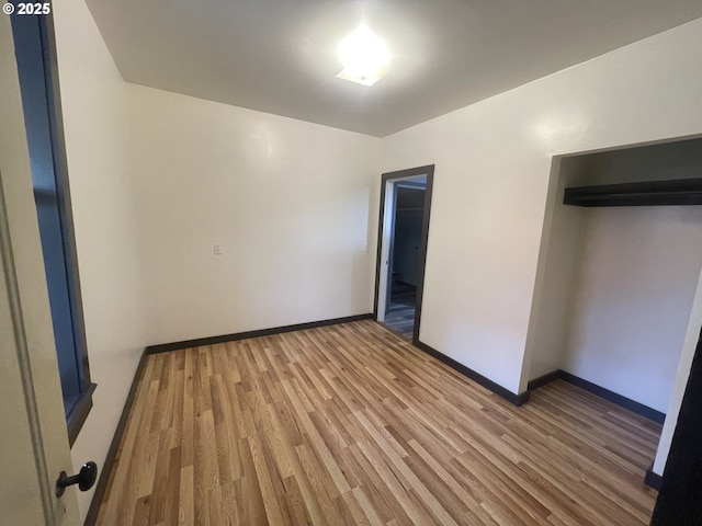 unfurnished bedroom featuring hardwood / wood-style flooring and a closet