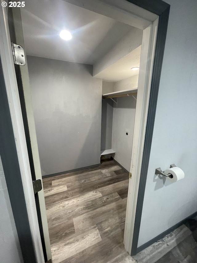 interior space with dark hardwood / wood-style floors and electric dryer hookup