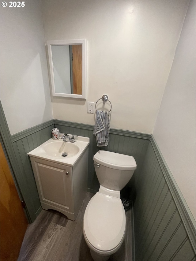 bathroom featuring vanity, toilet, and hardwood / wood-style floors