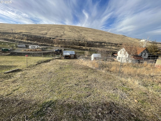 view of yard featuring a mountain view and a rural view