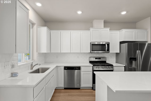 15470 NW Blueblossom St, Portland, OR 97229 - kitchen featuring appliances with stainless steel finishes, white cabinets, light countertops, and recessed lighting