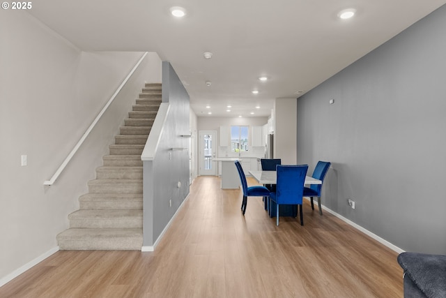 15470 NW Blueblossom St, Portland, OR 97229 - dining area with light wood-style flooring, recessed lighting, and stairs