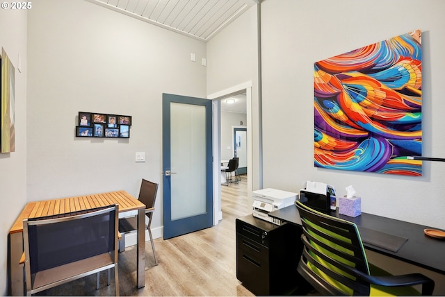 office featuring light hardwood / wood-style floors and french doors