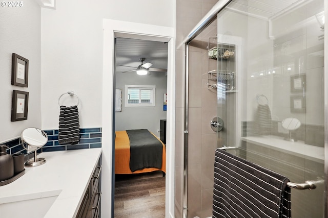 bathroom with ceiling fan, hardwood / wood-style floors, vanity, and an enclosed shower