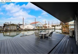 deck with a boat dock and a water view